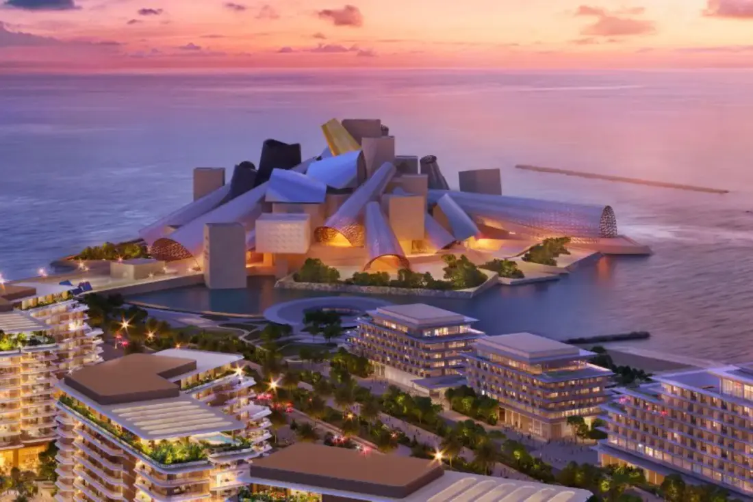 Aerial view of the Guggenheim Abu Dhabi building on the Saadiyat waterfront at sunset