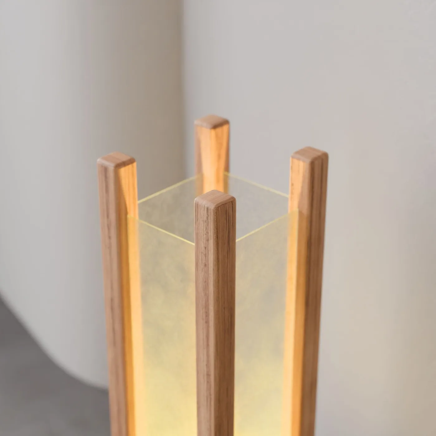A timber floor lamp giving off a warm golden glow